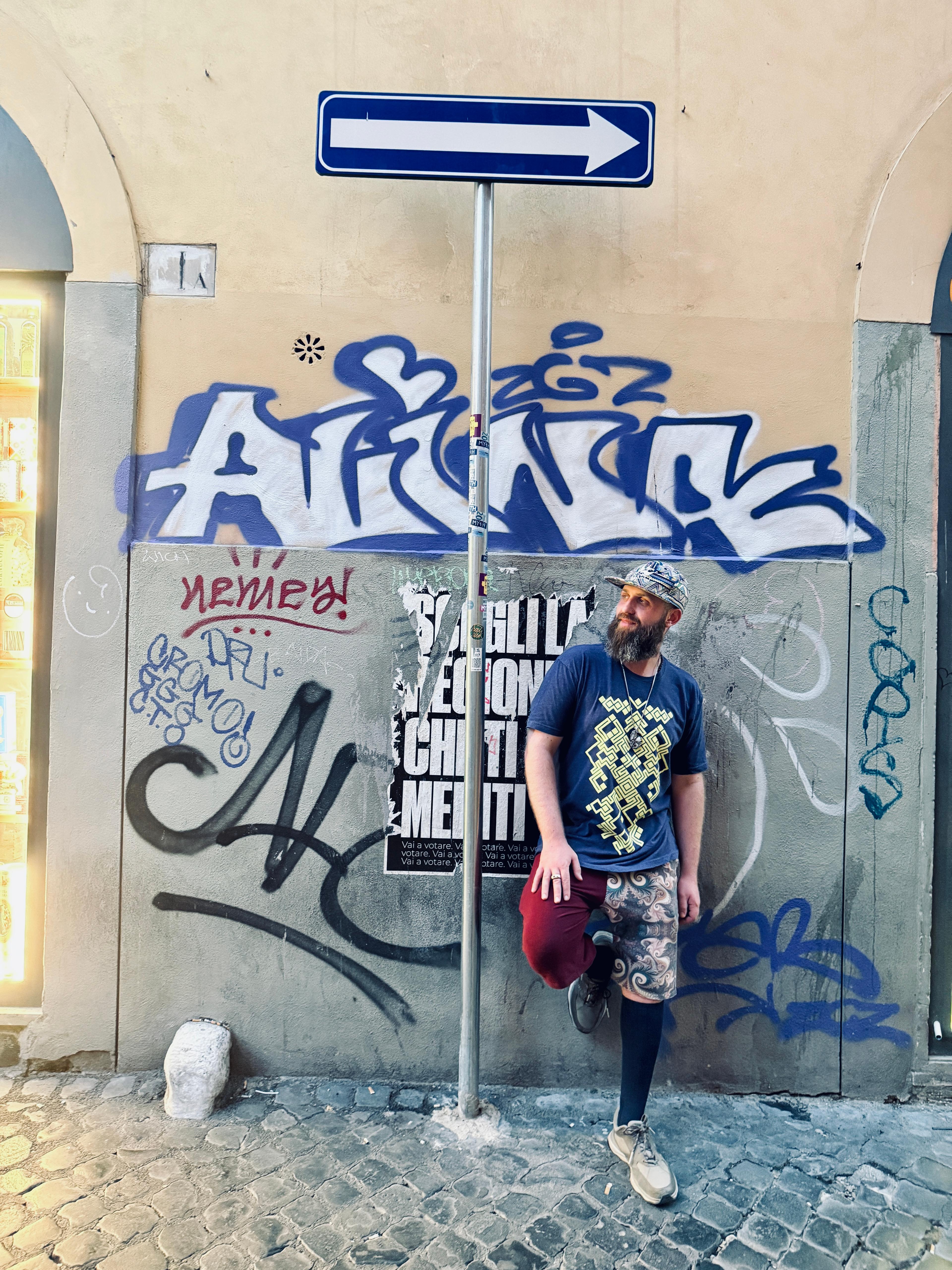 Brother Nature in front of graffiti wall